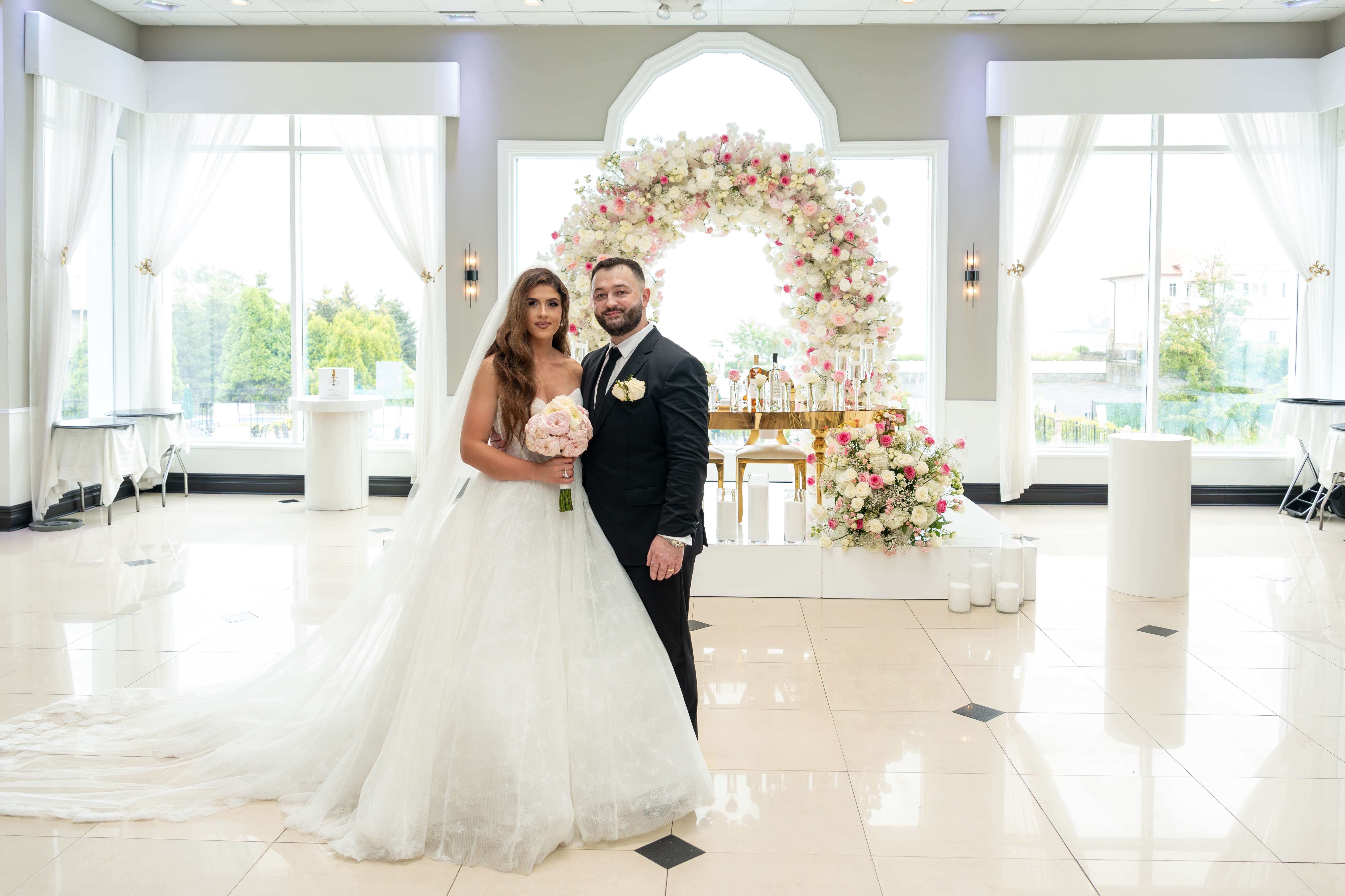 Wedding couple portrait in front of romantic floral ceremony setup